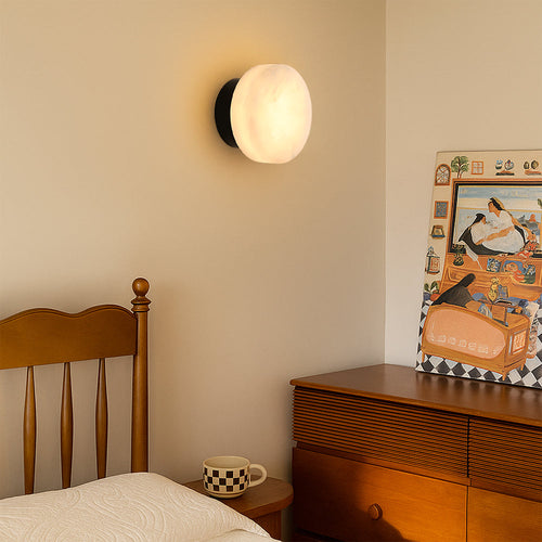 Luminária de parede em mármore contemporâneo com iluminação suave e difusa, ideal para complementar ambientes sofisticados.