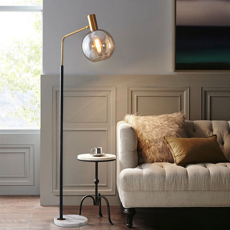 Luminária de mesa em estilo nórdico minimalista com cúpula de vidro e base de mármore para uma luz elegante.