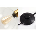 Luminária de mesa em estilo nórdico minimalista com cúpula de vidro e base de mármore para uma luz elegante.