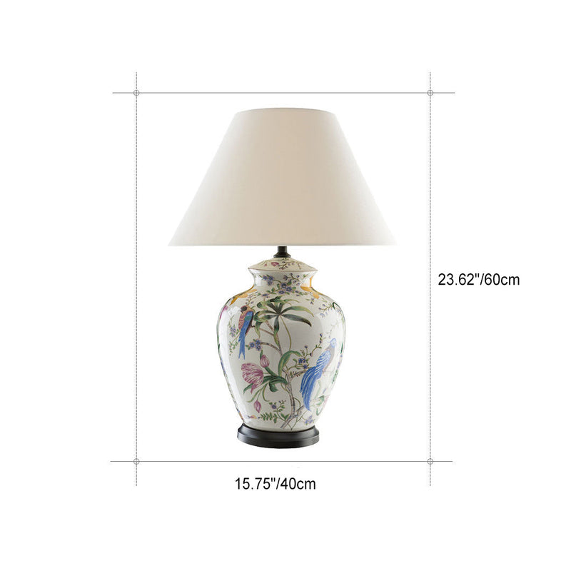 Luminária de mesa estilo retrô em cerâmica com design de flores e pássaros.
