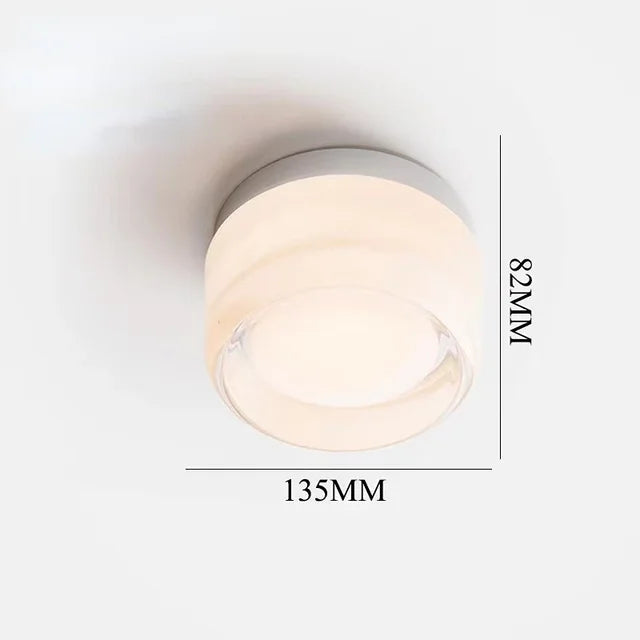 Luminária de parede circular contemporânea com iluminação difusa e acabamento minimalista em metal polido.