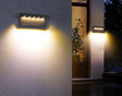Luminária de parede elegante com iluminação LED ambiente e acabamento resistente em aço inoxidável para exteriores.
