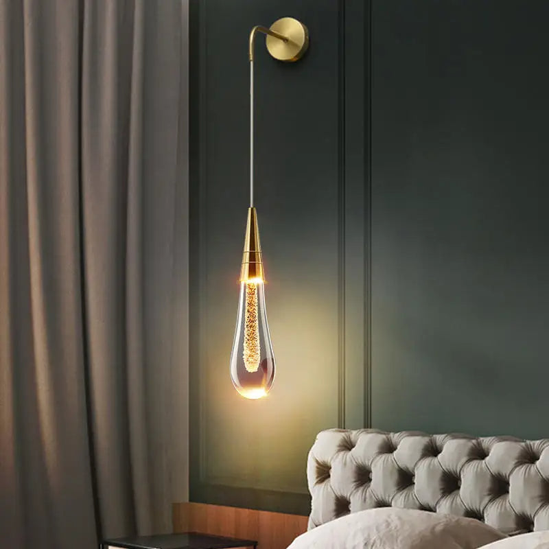 Luminária de parede em LED com design escultural em forma de gota d'água, oferecendo uma iluminação suave e envolvente.