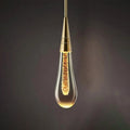 Luminária de parede em LED com design escultural em forma de gota d'água, oferecendo uma iluminação suave e envolvente.