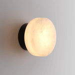 Luminária de parede em mármore contemporâneo com iluminação suave e difusa, ideal para complementar ambientes sofisticados. Padrão