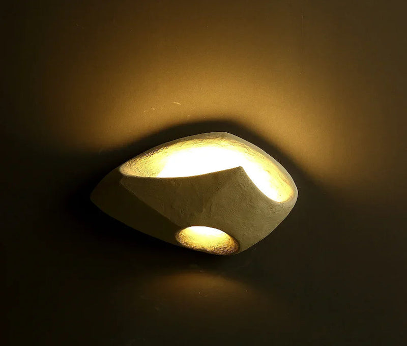 Luminária de parede suave e orgânica, com design inspirado na filosofia Wabi-sabi, que traz uma atmosfera de serenidade e beleza imperfeita ao seu espaço.