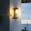 Luminária externa cilíndrica de metal e vidro, resistente à água IP65 com design moderno.